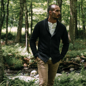 fit model walking in the woods in The Crawford Sweater in Charcoal