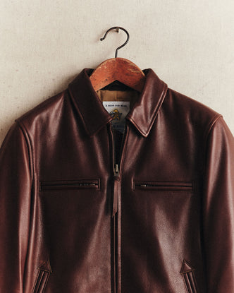 fit model sitting on a motorcycle in The Moto Jacket in Espresso Steerhide