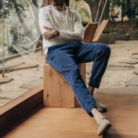 fit model sitting wearing The Apres Pant in Indigo Waffle