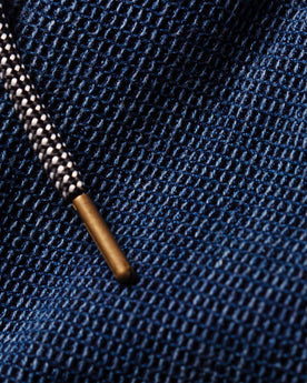 material shot of the metal tipped drawcord on The Apres Pant in Indigo Waffle, Bottoms by Taylor Stitch