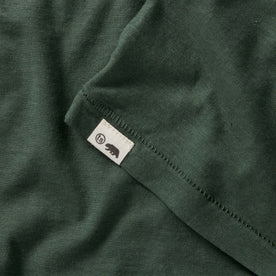 material shot of the logo on The Cotton Hemp Tee in Pine