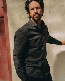 fit model adjusting the cuffs on The Jack in Coal Jaspe Check Oxford, Wovens by Taylor Stitch