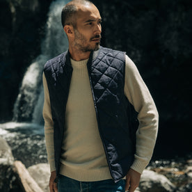 fit model walking in The Quilted Bomber Vest in Navy Dry Wax