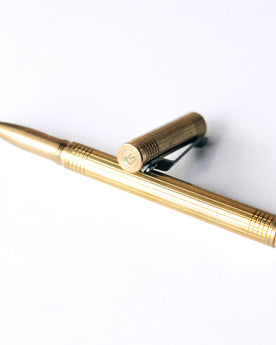 material shot of the cap and pen on The Pen in Brass, Accessories by Taylor Stitch