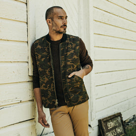 fit model with his hand in his pocket of The Workhorse Vest in Camo Boss Duck