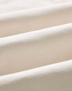 material shot of the sleeve on The Organic Cotton Tee in Vintage White, Knits by Taylor Stitch