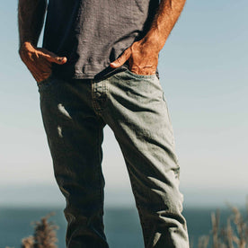 our fit model wearing The Slim Jean in 24-Month Wash Japanese Selvage—on the beach, hands in pockets