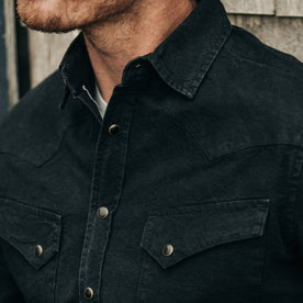fit model wearing The Western Shirt in Washed Black Selvage Chambray, cropped chest shot