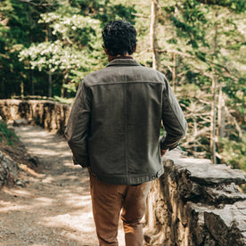 our fit model wearing The Long Haul Jacket in Moss Brushed Reverse Sateen—walking away from camera