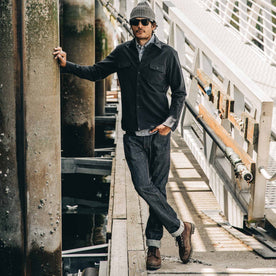 our fit model wearing The Slim Everyday Jean—standing on a dock looking ahead