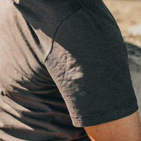 our fit model wearing The Standard Issue Tee in Charcoal Hemp—sleeve shot