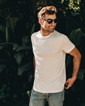 our fit model wearing The Standard Issue Tee in Natural Hemp—hand near pocket shot, Knits by Taylor Stitch