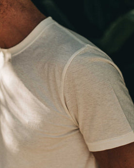 our fit model wearing The Standard Issue Tee in Natural Hemp—sleeve shot, Knits by Taylor Stitch