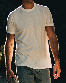 our fit model wearing The Standard Issue Tee in Natural Hemp—cropped shot chin down, Knits by Taylor Stitch