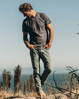 our fit model wearing The Standard Issue Tee in Navy Hemp—outside on the beach walking, Knits by Taylor Stitch