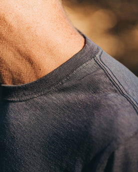 our fit model wearing The Standard Issue Tee in Navy Hemp—cropped shot of shoulder and collar, Knits by Taylor Stitch
