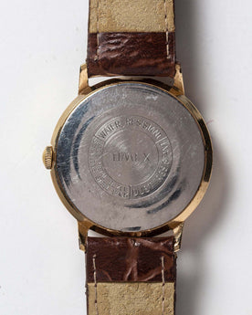 flatlay of the 1969 Timex Marlin, shown from the back, Accessories by Taylor Stitch