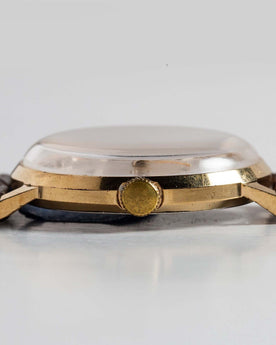 flatlay of the 1969 Timex Marlin, shown from the side, Accessories by Taylor Stitch