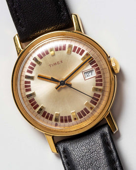 material shot of the watchface on The 1974 Timex Mercury Calendar Gold, Accessories by Taylor Stitch