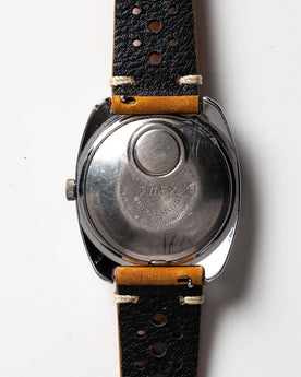 flatlay of 1976 Timex Electric Dynabeat, shown from the back, Accessories by Taylor Stitch