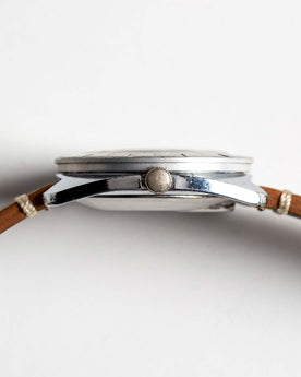flatlay of 1976 Timex Electric Dynabeat, shown from the side, Accessories by Taylor Stitch