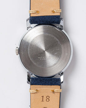 flatlay of the 1976 Timex Mercury Blue, shown from the back, Accessories by Taylor Stitch