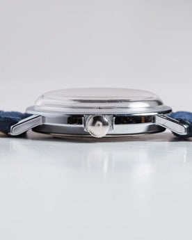 flatlay of the 1976 Timex Mercury Blue, shown from the side, Accessories by Taylor Stitch