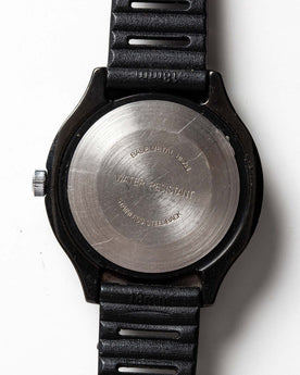 flatlay of the 1977 Timex Black Max, shown from the back, Accessories by Taylor Stitch