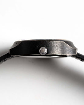 flatlay of the 1977 Timex Black Max, shown from the side, Accessories by Taylor Stitch