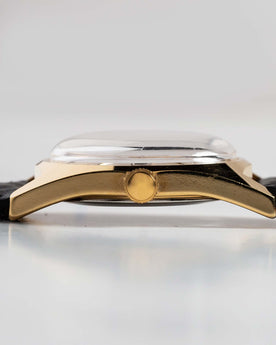 flatlay of the 1978 Timex Gold Marlin, shown from the side, Accessories by Taylor Stitch