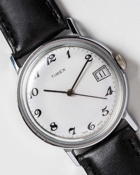 flatlay of the 1978 Timex Mercury, shown close up, Accessories by Taylor Stitch