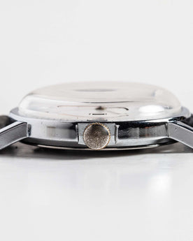 flatlay of the 1978 Timex Mercury, shown from the side, Accessories by Taylor Stitch