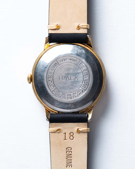 flatlay of the 1975 Timex Viscount, shown from the back, Accessories by Taylor Stitch