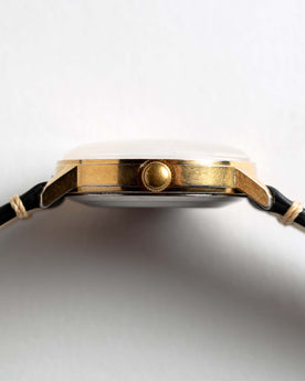 flatlay of the 1975 Timex Viscount, shown from the side, Accessories by Taylor Stitch