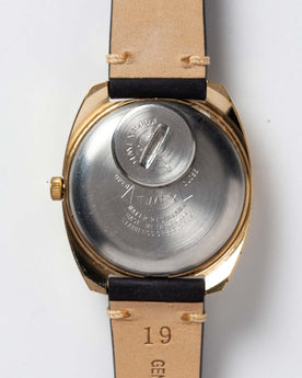 flatlay of the 1978 Timex Q Quartz, shown from the back, Accessories by Taylor Stitch