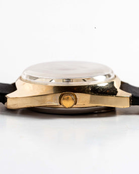 flatlay of the 1978 Timex Q Quartz, shown from the side, Accessories by Taylor Stitch