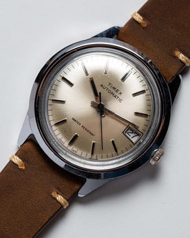 flatlay of  the 1978 Timex Viscount M108, shown close up, Accessories by Taylor Stitch