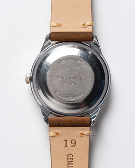 flatlay of the 1978 Timex Viscount M108, shown from the back, Accessories by Taylor Stitch