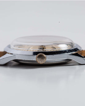 flatlay of the 1978 Timex Viscount M108, shown from the side, Accessories by Taylor Stitch