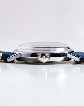 flatlay of the 1974 Timex Viscount M31, from the side, Accessories by Taylor Stitch