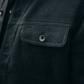 fit model wearing The Long Haul Jacket in Black Indigo Sashiko—cropped shot of chest button