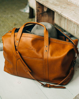 outdoor material shot of The Weekender Duffle Bag in Saddle Tan, Accessories by Taylor Stitch