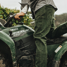 Our fit model wearing The Chore Pant in Dark Olive Tuff Duck from Taylor Stitch.