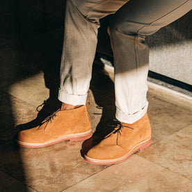 our fit model wearing The Unlined Chukka in Butterscotch Weatherproof Suede—pants cuffed with strong shadows on floor