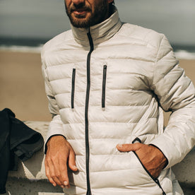 our fit model wearing The Taylor Stitch x Mission Workshop Farallon Jacket in fog—zipped up on the beach