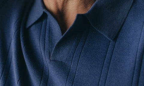 fit model showing off The Newton Polo in Heather Blue