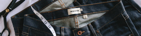Closeup shot of our jeans with a measuring tape