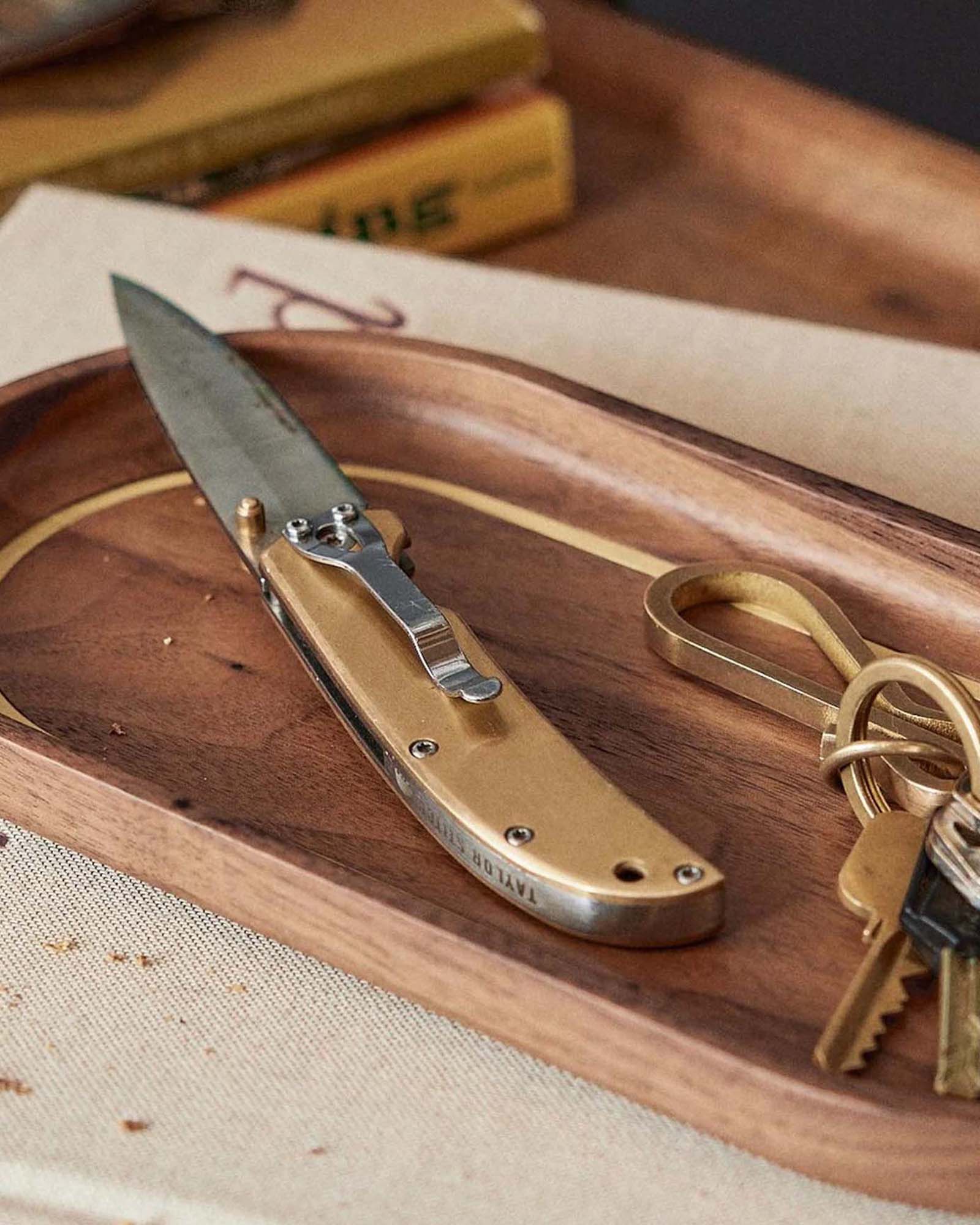 The Drop Point Knife in Brass on the valet tray, Accessories by Taylor Stitch