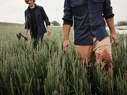 Two farmers strolling through rice field