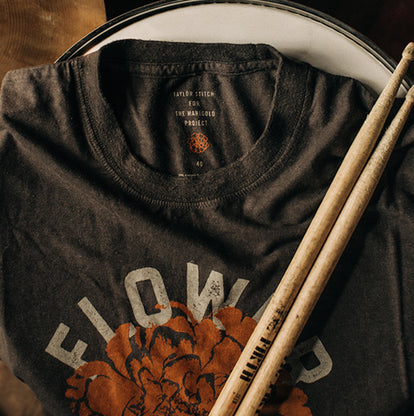 The Flower Power cotton hemp tee with drumsticks on top of it